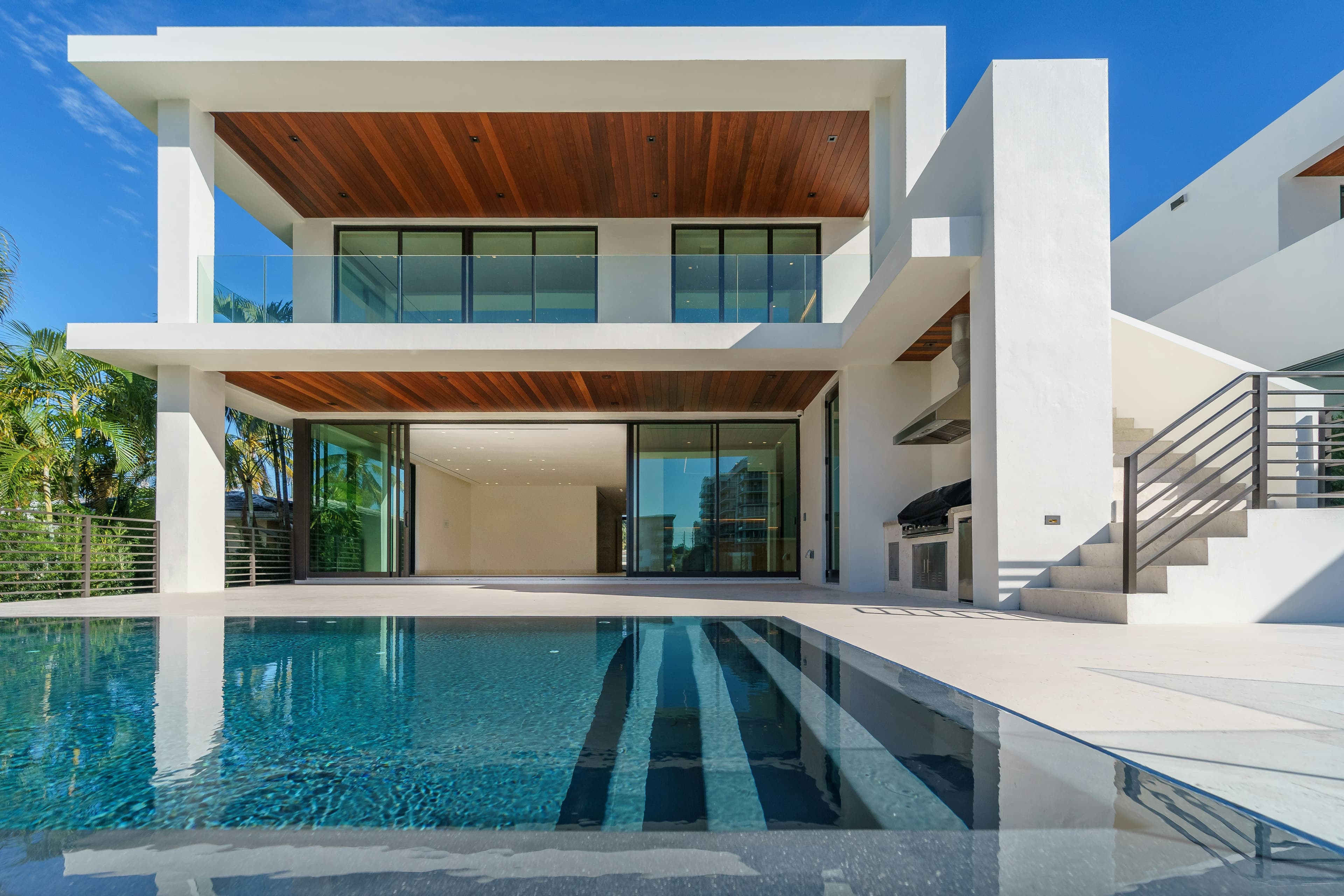 Modern beachfront villa with pool at dusk